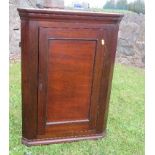A Georgian corner cupboard, opening to reveal shelves, width 21ins x height 29.5ins