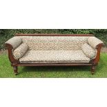 A 19th century rosewood showwood settee, with carved decoration to the arms, raised on turned