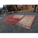 An Eastern design rug, decorated with a central panel to a pink ground, 51ins 32ins, another dark