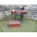 A Singer sewing machine, with treadle base, together with accessories