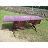 A reproduction writing table, with drop flap sides. having red leather inset to the top and flaps,