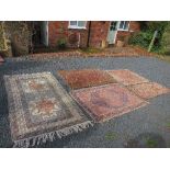 An Eastern design rug, decorated with a central field of blue and pink to a cream ground and
