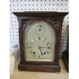 An Astral of Coventry oak cased mantel clock, with silvered dial and striking movement, height 8.