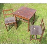 A child's stained pine table and two chairs