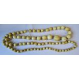 A graduated row of ivory beads