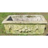 A concrete garden planter, with embossed decoration, 23ins x 12ins, height 8ins