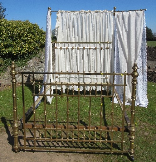 A James Shoolbred & Co brass double bed, with drapes, 83ins x 60ins, height 84insCondition Report: