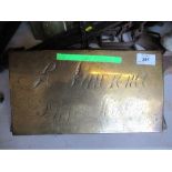 A brass plate, inscribed R Lawrence Dressmaker