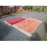 A large Eastern design rug, decorated with medallions in a central field to an orange ground to a