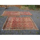 An Eastern design rug, decorated with a central patterned panel in a pink ground, to a patterned