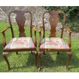 A pair of Queen Anne style open arm dining chairs