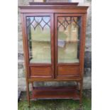 An Edwardian mahogany and inlaid display cabinet, damage to glazing bars, with shelf under, width