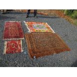 An Eastern design rug, decorated with blue medallions in a central field to a brown ground and