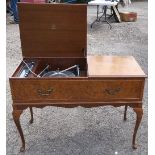 A Drynatron walnut veneered and mahogany radiogram, with radio and record player, the case on scroll