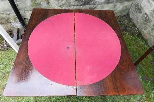 A 19th century fold over games table, raised on a turned and carved column, with four carved - Image 3 of 4