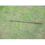 An antique metal crook, on a wooden shaft,