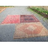 An Eastern design rug, with a burgundy ground to a patterned border 73ins x 60ins, another rug