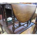 A 20th century oak gateleg dining table, with barley twist supports, 58.5ins x 41.5ins, height