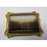 A late 19th century yellow metal rectangular brooch, of concave outline, with a rectangular agate