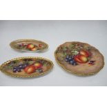 A Royal Worcester plate, decorated with fruit, diameter 7.75ins, together with an oval dish hand