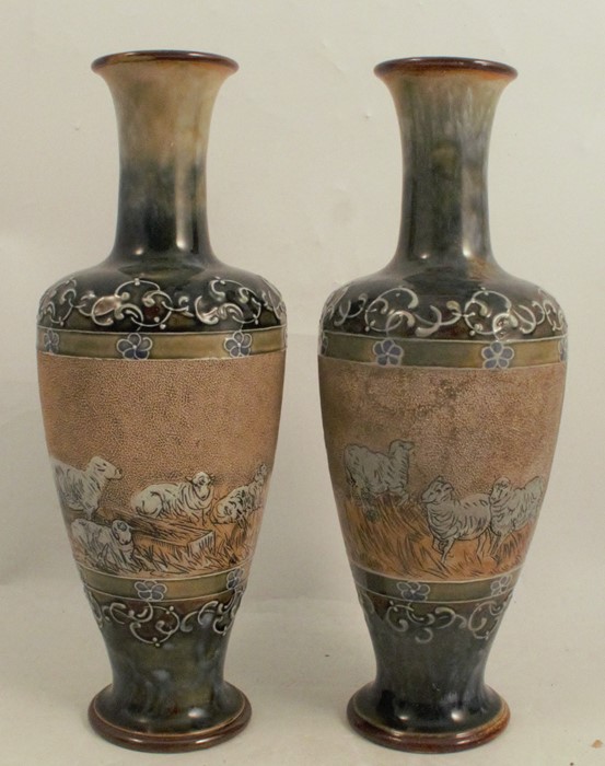 A pair of Doulton Lambeth stoneware vases, decorated with a band of sheep and dogs by Hannah Barlow,
