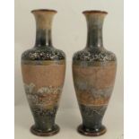 A pair of Doulton Lambeth stoneware vases, decorated with a band of sheep and dogs by Hannah Barlow,