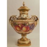 A Royal Worcester covered vase, decorated half round with hand paint fruit by Freeman, shape