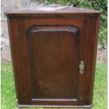 A 19th century mahogany corner cupboard, the door opening to reveal shaped shelves, width 25.5ins