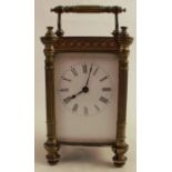 A gilt metal cased carriage clock, with white enamel dial and Roman numerals, height including