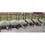 A set of six Edwardian mahogany dining chairs, with short galleried back and turned legs