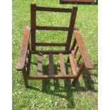 An oak Arts and Crafts style child's chair, with fold down back and square section galleried