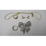 A gold coloured necklace and matching earrings and ring, set with stones, together with a bow brooch