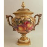 A Royal Worcester covered vase, decorated half round with hand painted fruit by Freeman, to gilt