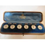 A cased set of six dress studs, in mother of pearl and green enamel