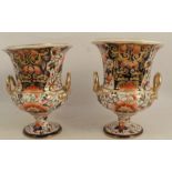 A pair of 19th century Derby porcelain campana shaped urns, decorated in the Imari palette, height