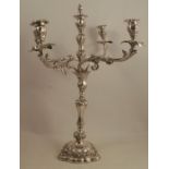 A Victorian silver four branch candelabrum, the central light having four scroll branches, raised on