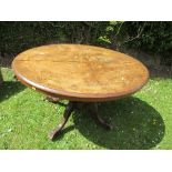 A 19th century oval burr walnut centre table, the quarter veneered top with marquetry inlay,