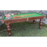 An oak dining snooker table, with three piece top, raised on turned legs with adjusters to base,