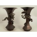 A pair of Japanese bronze hexagonal shaped trumpet vases, applied with a dragon in relief