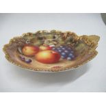 A Royal Worcester circular dish, decorated with hand painted fruit to a gilt scallop handle, by