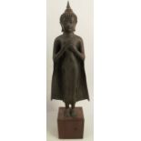 A Thai bronze standing figure, of Buddha, raised on wooden a platform, height 22.5ins - good