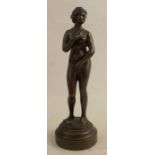 A bronze figure, of a standing nude female, on stepped circular base, height 7ins