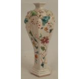 An 18th century Chinese soft paste vase, of octagonal baluster form, decorated with applied leaves