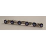 A white gold sapphire and diamond bar brooch