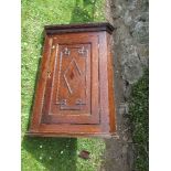 A 17th century style oak corner cupboard, with moulded front door, width 26ins x height 35ins
