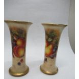 A pair of Royal Worcester spill vases, decorated half round with hand painted fruit by Freeman,