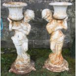 A pair of painted metal garden urns, formed as figures holding campagna shaped urns, height 33.5ins