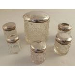 Six various hallmarked silver topped dressing table jars, four with cut glass bases