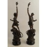 A pair of spelter figures, of Classical females standing with lions on a rocky base, height 20ins