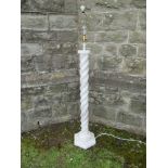An alabaster standard lamp, having a turned column on a stepped octagonal base, height 36ins